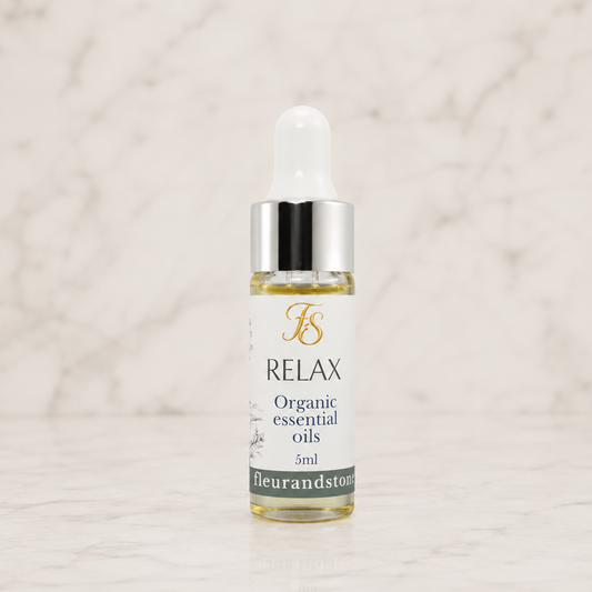 Fleur & Stone Relax Essential Oil Blend in a 5ml glass bottle with 100% pure organic therapeutic-grade essential oils on a light marble background.