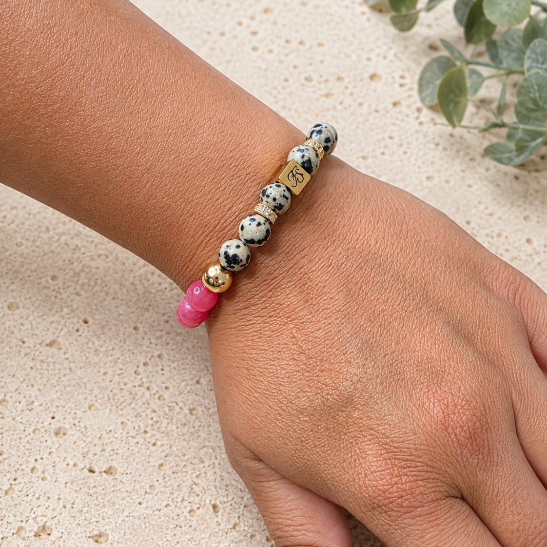 Pink Horizon Dalmatian Jasper and Rhodochrosite gemstone bracelet worn on wrist, handcrafted by Fleur & Stone in Kerry, Ireland.