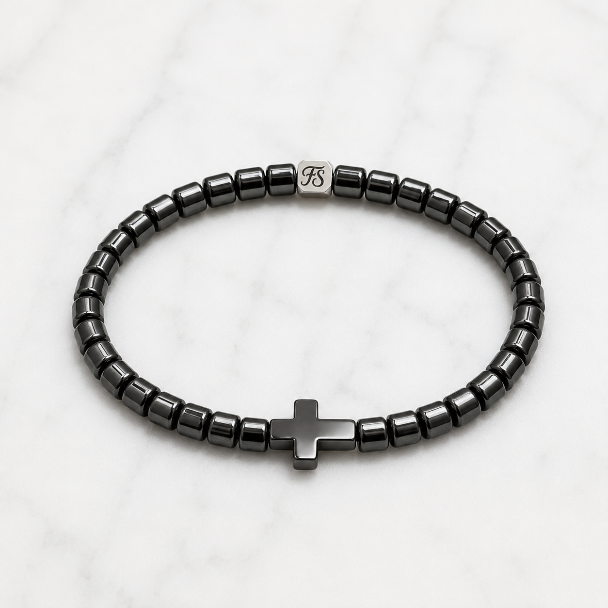 4mm Natural Hematite Cross bracelet with polished Hematite beads and stainless steel Fleur & Stone logo spacer.