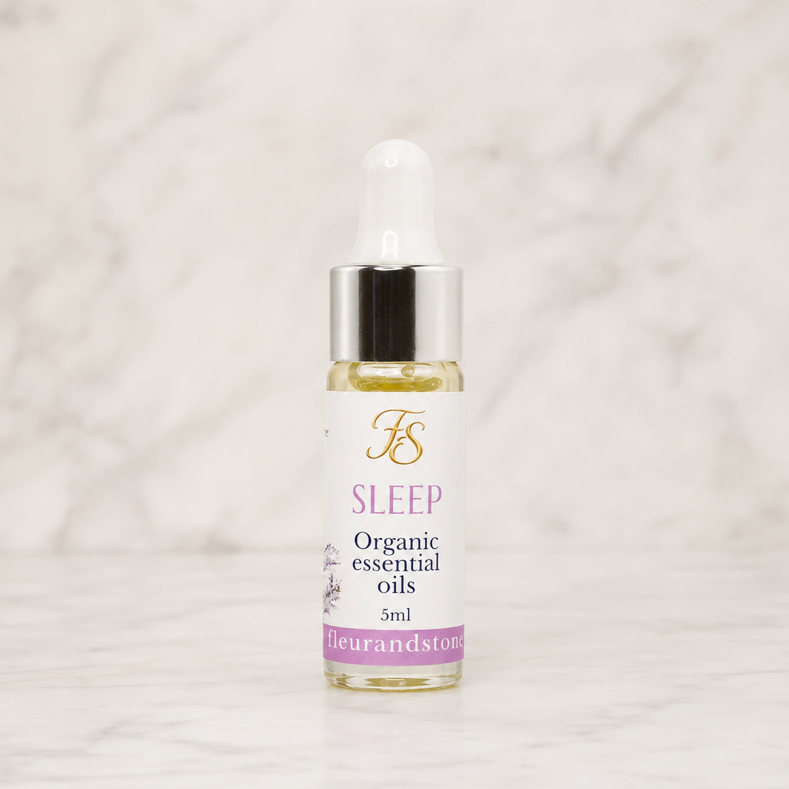 Fleur & Stone Sleep Essential Oil Blend in a 5ml glass bottle made with 100% pure organic therapeutic-grade essential oils on a light marble background.