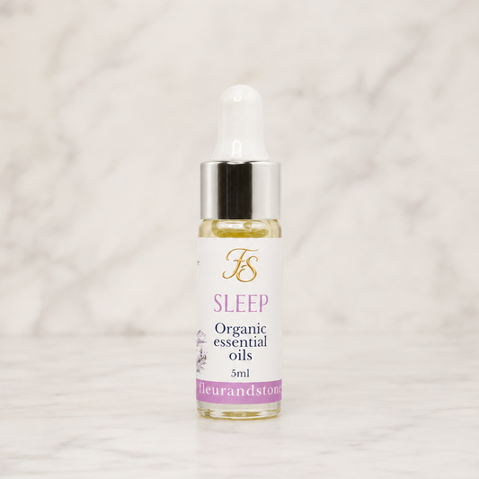 Fleur & Stone Sleep Essential Oil Blend in a 5ml glass bottle made with 100% pure organic therapeutic-grade essential oils on a light marble background.