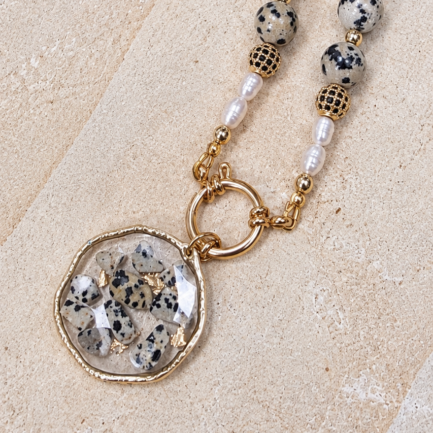 Close-up of Dalmatian Jasper necklace with freshwater pearls, black pavé beads and handmade resin pendant