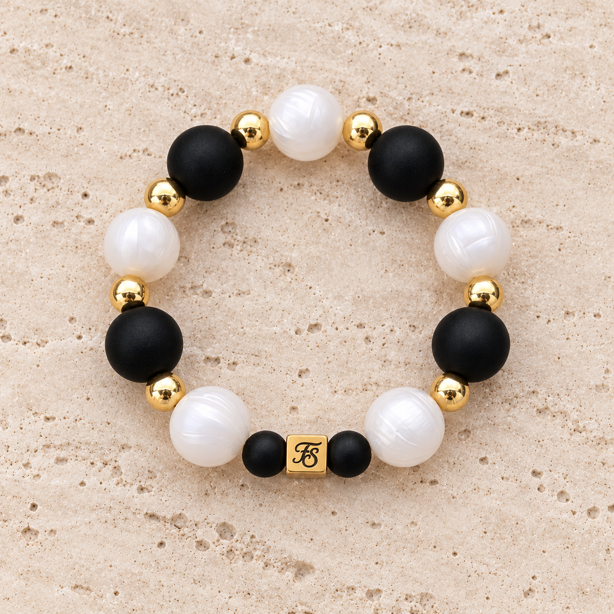Midnight Pearl black and pearly white silicone bead bracelet with gold hematite accents by Fleur & Stone